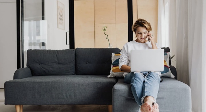 A guest working from the sofa of a Flex apartment
